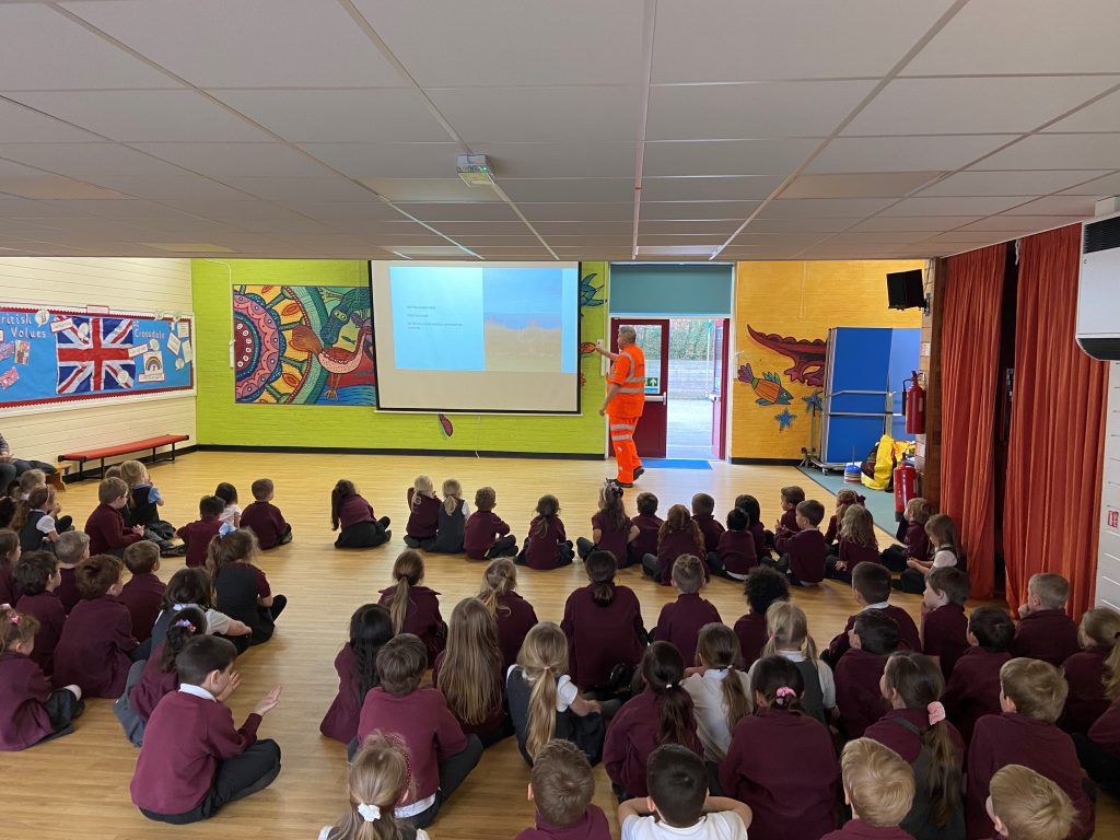 A Bridgeway employee delivering a rail safety talk to primary school children