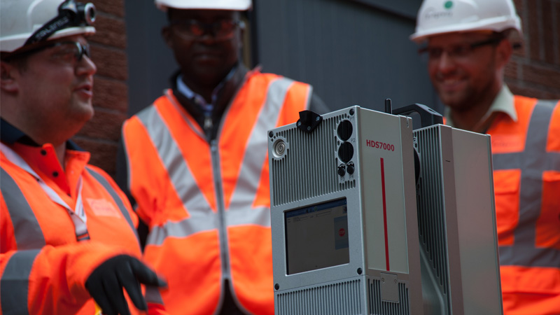 Bridgeway team members setting up a 3D laser scanner on site