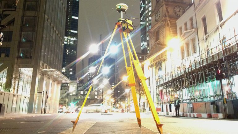 Bridgeway geomatics survey equipment set up on a city street at night near Liverpool Street