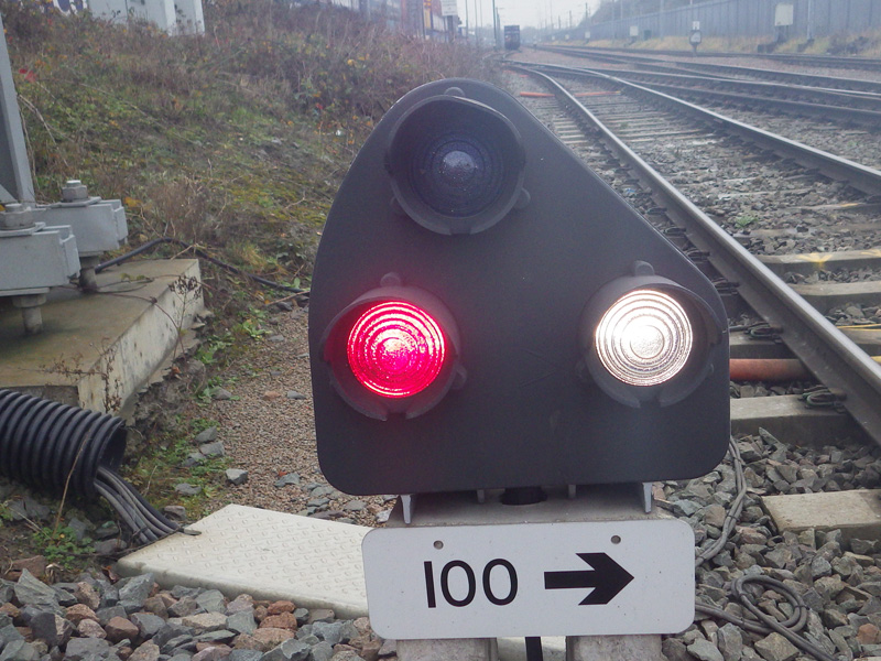 A lineside railway signal showing red and white aspects