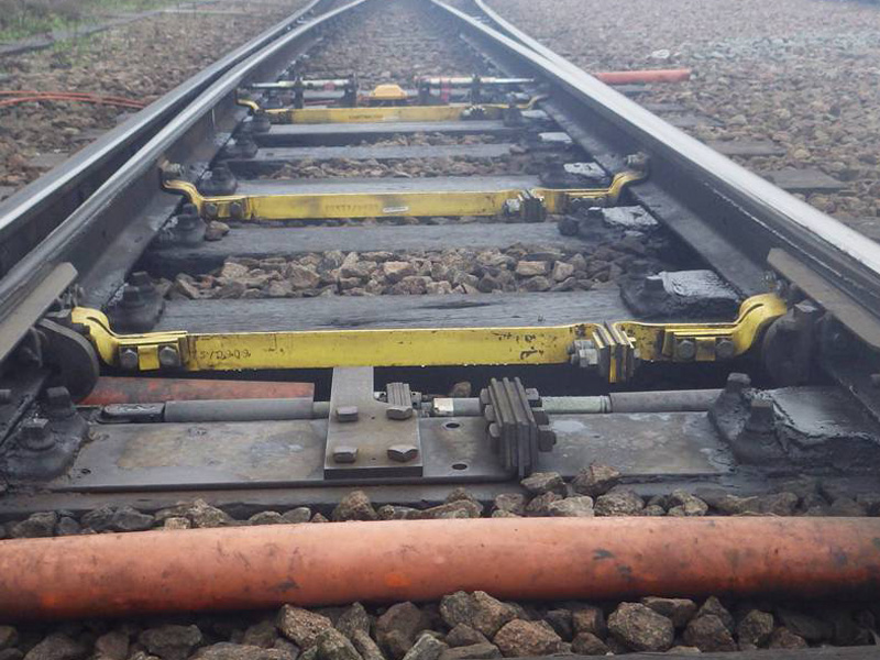 Close-up of railway signalling equipment fixed to the track