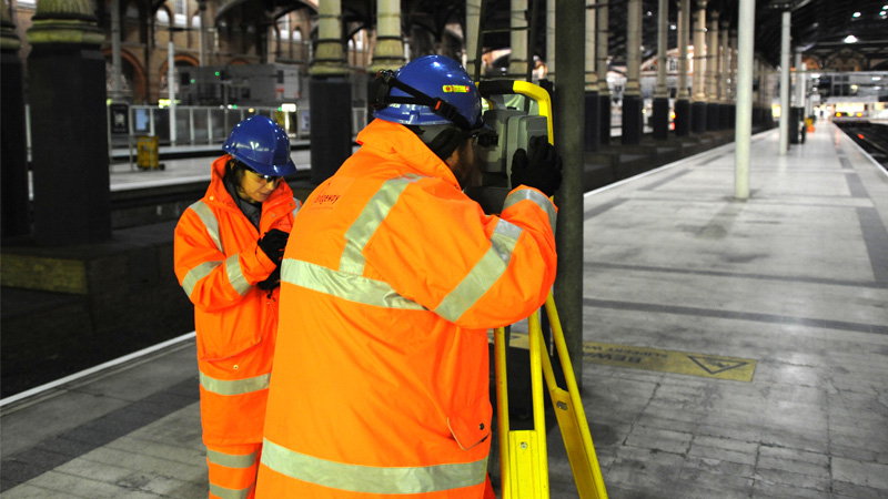 Bridgeway surveyors carrying out a topographical survey on a station platform at night